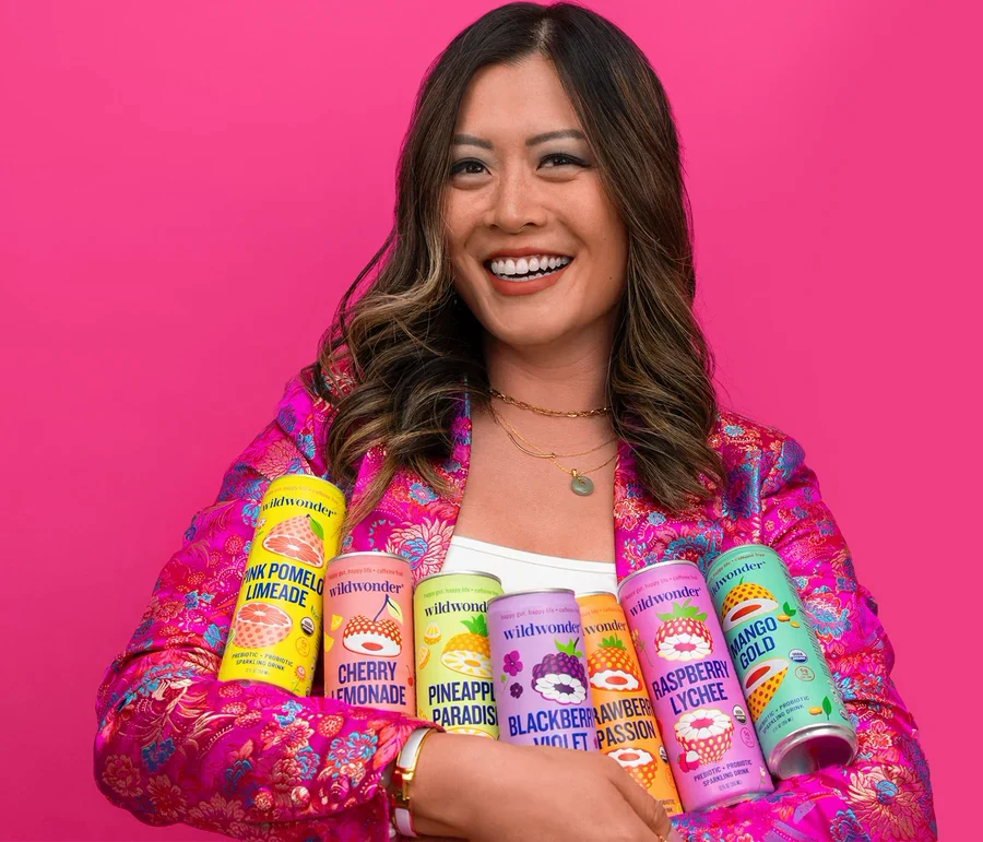 Rosa, founder of wildwonder, holding an armful of cans